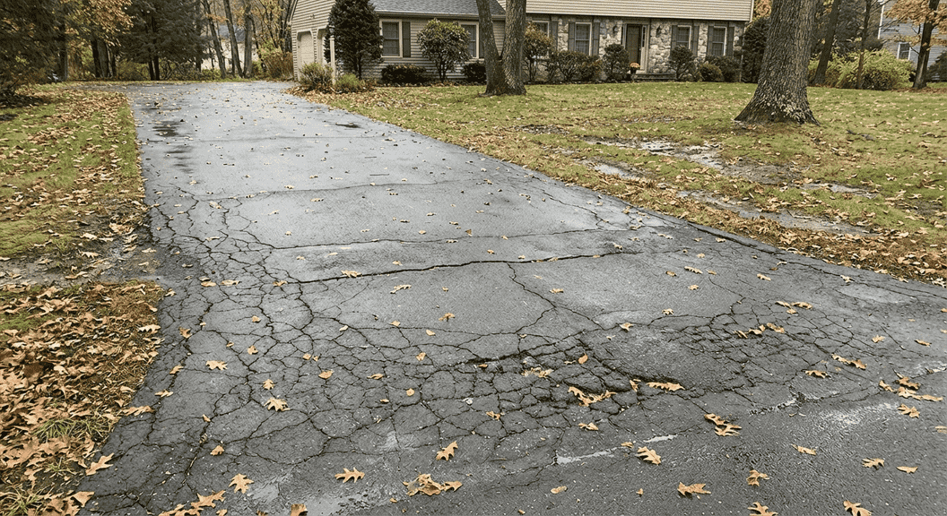 Driveway in Eastern Connecticut showing cracks and signs of damage